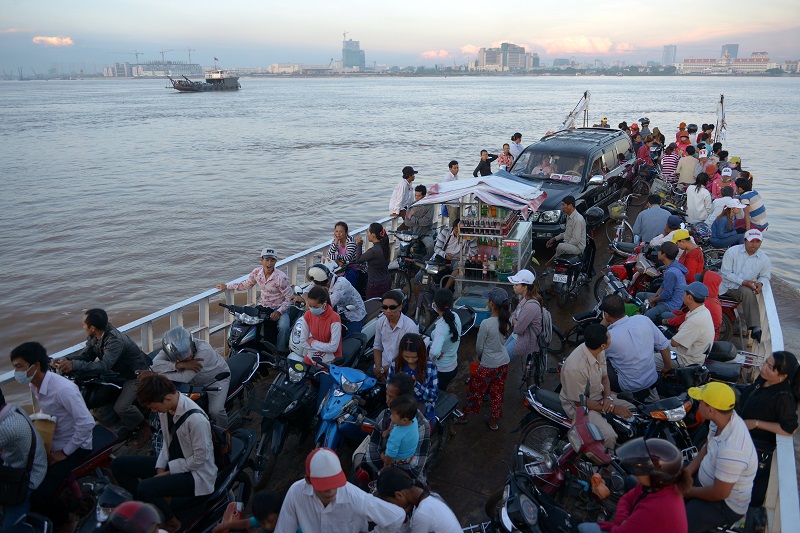 A ferry transports Cambodian people across the Mekong river in Phnom Penh on August 27, 2014. The Association of Southeast Asian Nations (ASEAN) has set 2015 as the target to create a single economic market across the 10-nation bloc that is home to some 600 million people. TANG CHHIN SOTHY/AFP/Getty Images.